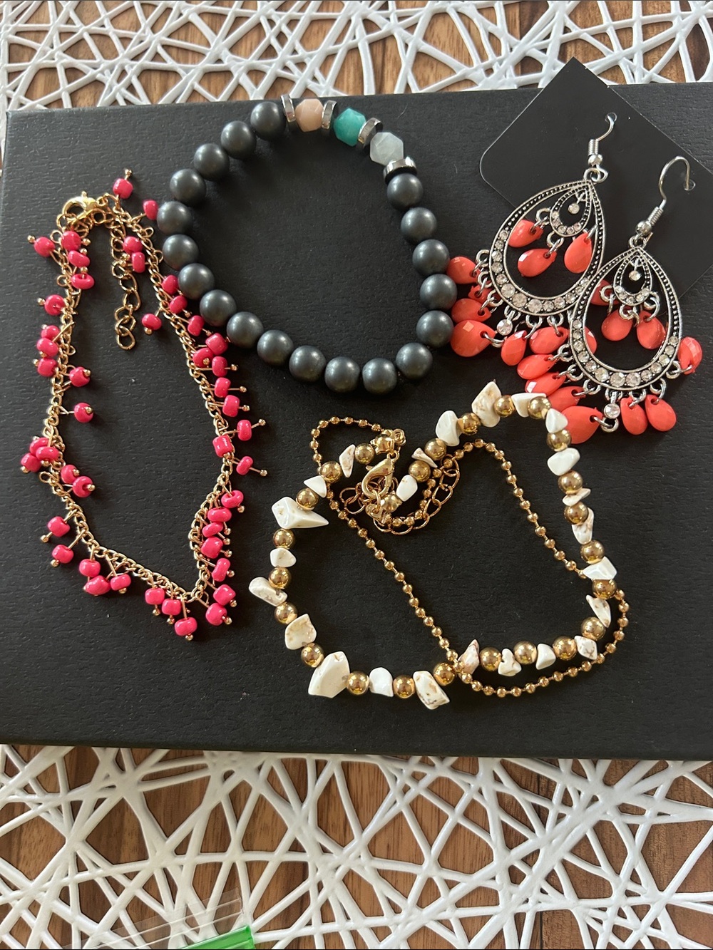 2 anklets/bracelets, 1 bead bracelet and 1 pair of coral pink earrings.